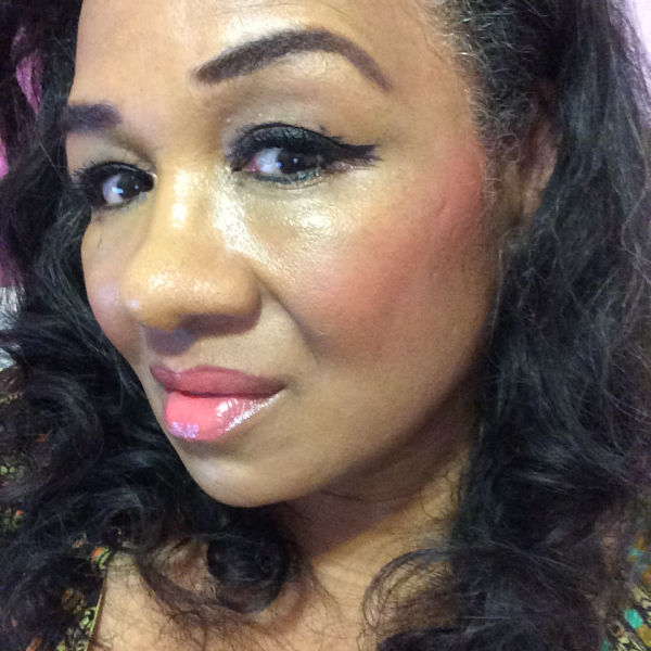 Tracey Brown wearing Milani Rose Powder Blush in Coral Cove on brown skin