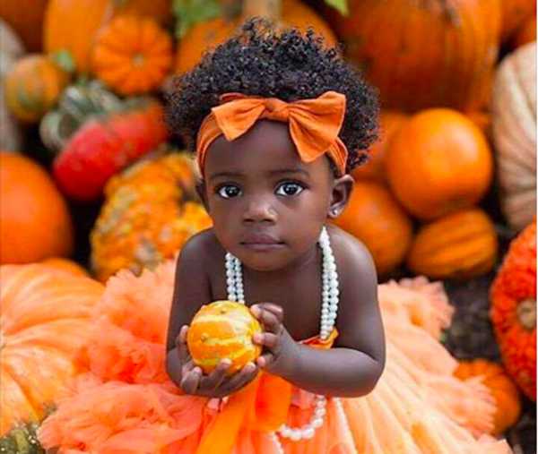 national pumpkin day beautiful little black girl and pumpkins