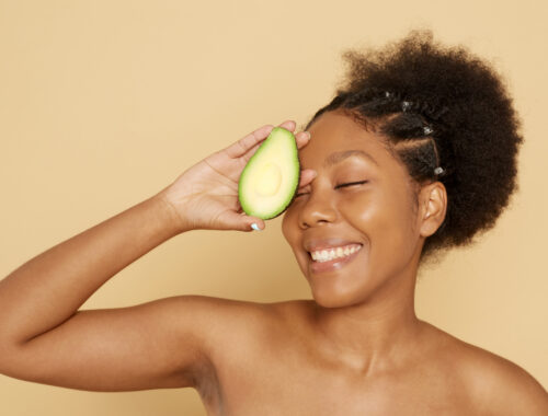 black woman with avocado national avocado day