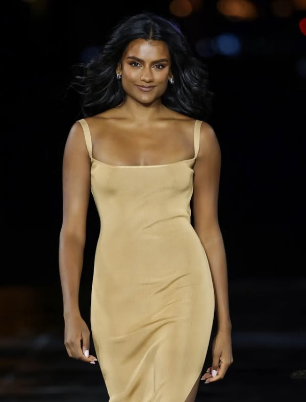 Simone Ashley wearing a gold dress and L’Oréal Paris beauty look at Le Défilé 2026