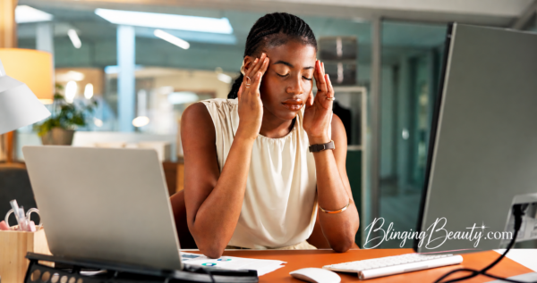 Black woman at desk wearing makeup for Friday Find Cubicle to Happy Hour